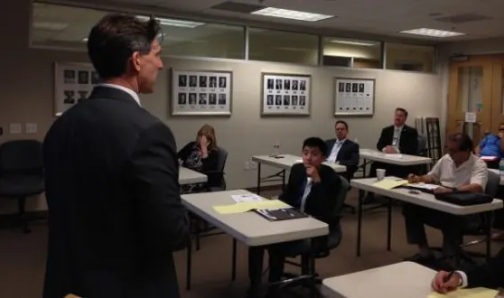 Instructor presenting to a group of professionals